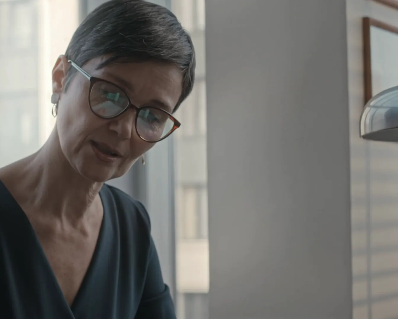 A solicitor listening closely to a client in a bright office