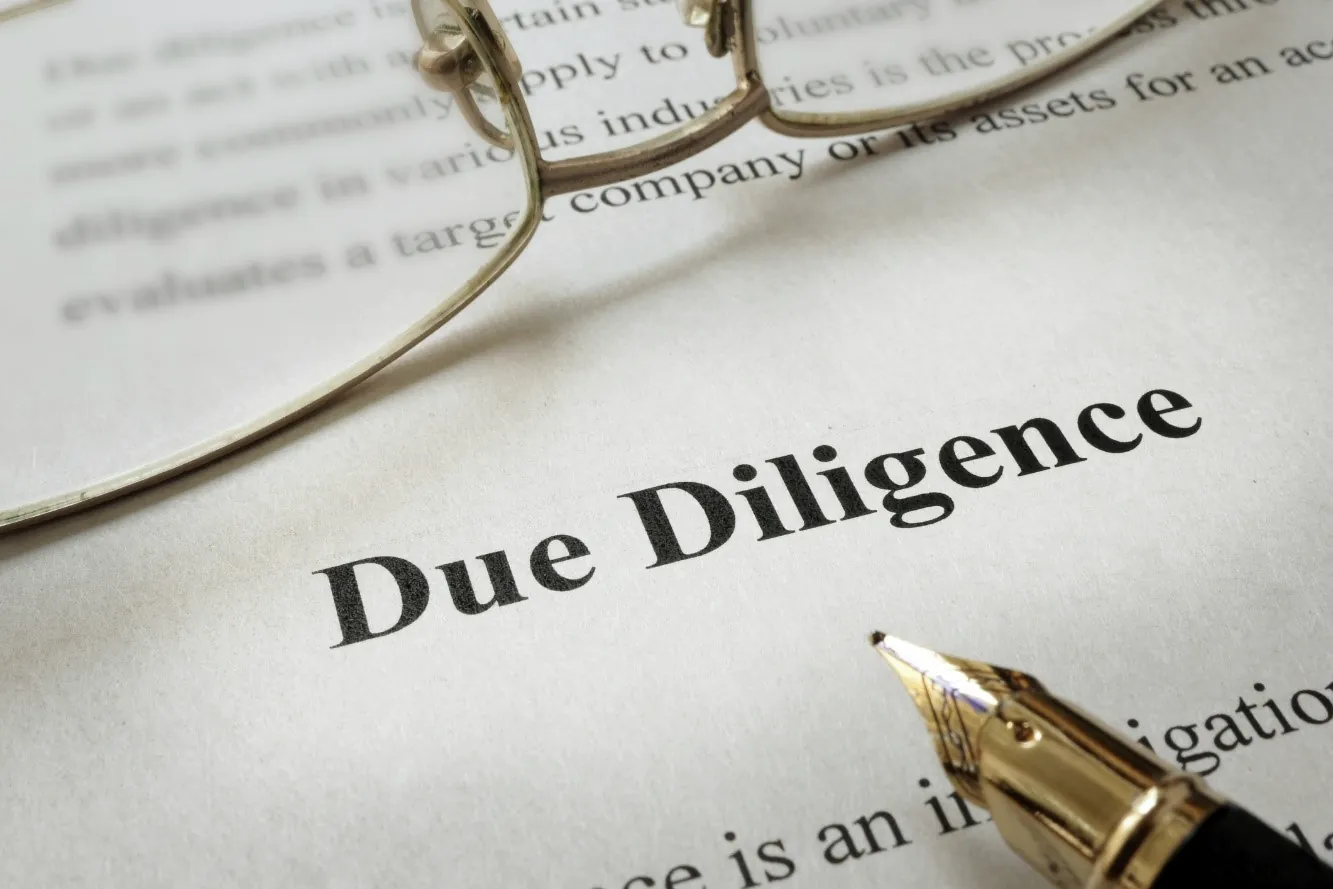 Reading glasses and a fountain pen resting on a legal document
