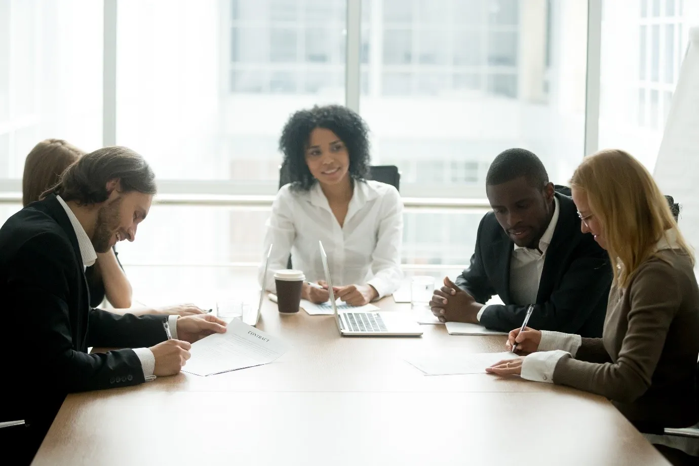 Colleagues in a business meeting around a boardroom table